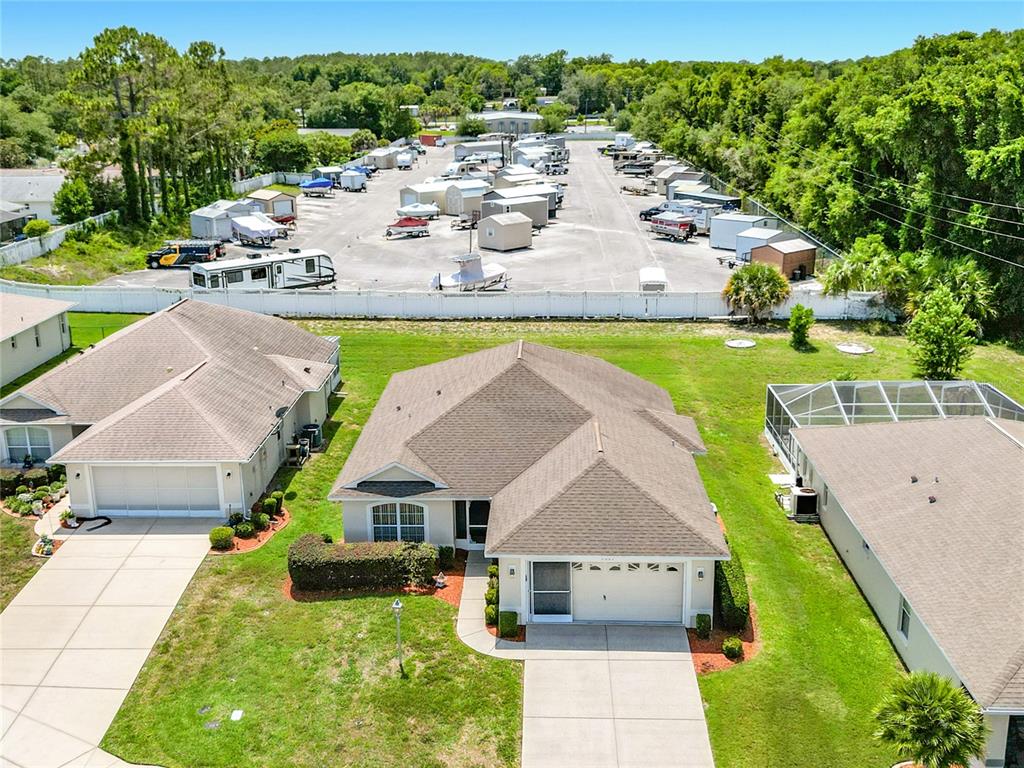 An aerial view shows two suburban houses with driveways and a nearby boat storage lot — 4683 N LAKE VISTA TRAIL, HERNANDO, FL