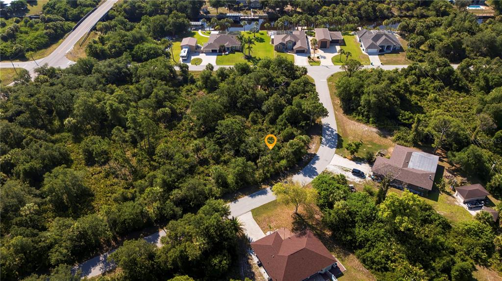 An aerial view shows a vacant, wooded residential lot marked by a yellow location pin — 3266 GABOR STREET, PORT CHARLOTTE, FL