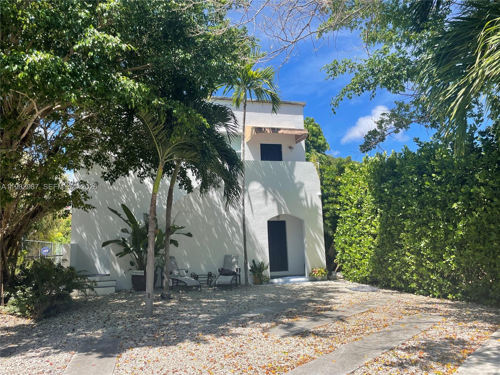 A white two-story house with a gravel yard, palm trees, and a hedge — 3421 SW 25th St # 01, Miami FL 33133, MIAMI, FL