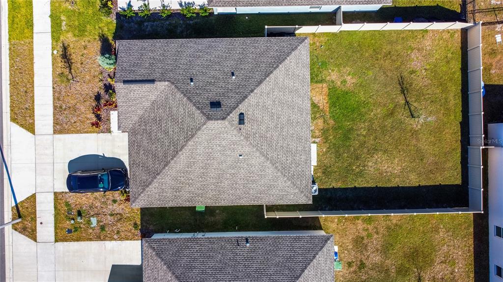 An aerial view shows a house with a shingled roof, a driveway, and a fenced yard — 2307 SCARLET AVENUE, WINTER HAVEN, FL