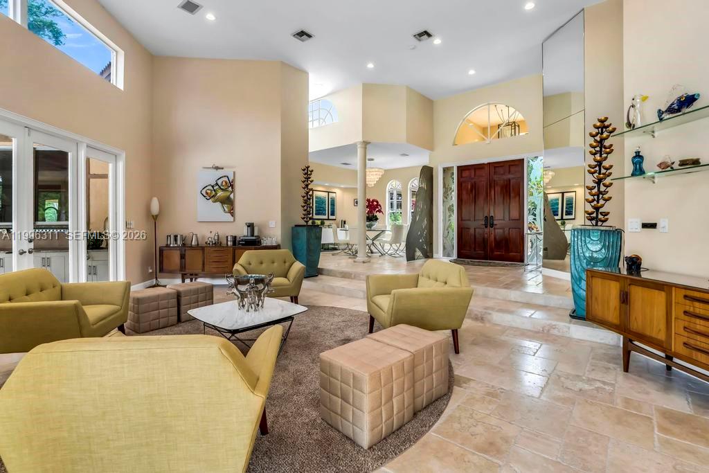 A spacious living room features vaulted ceilings, tile flooring, and a sunken seating area — 5328 E Leitner Dr, Coral Springs FL 33067, CORAL SPRINGS, FL
