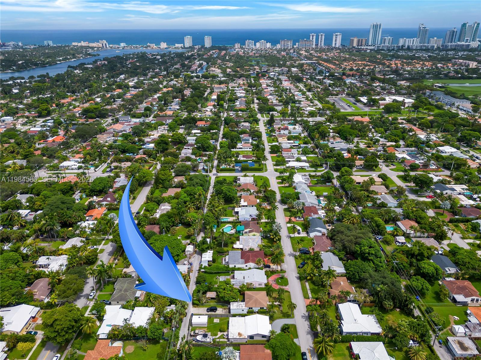 An aerial view shows a residential neighborhood with a blue arrow pointing to a house — 1539 Funston St, Hollywood FL 33020, HOLLYWOOD, FL