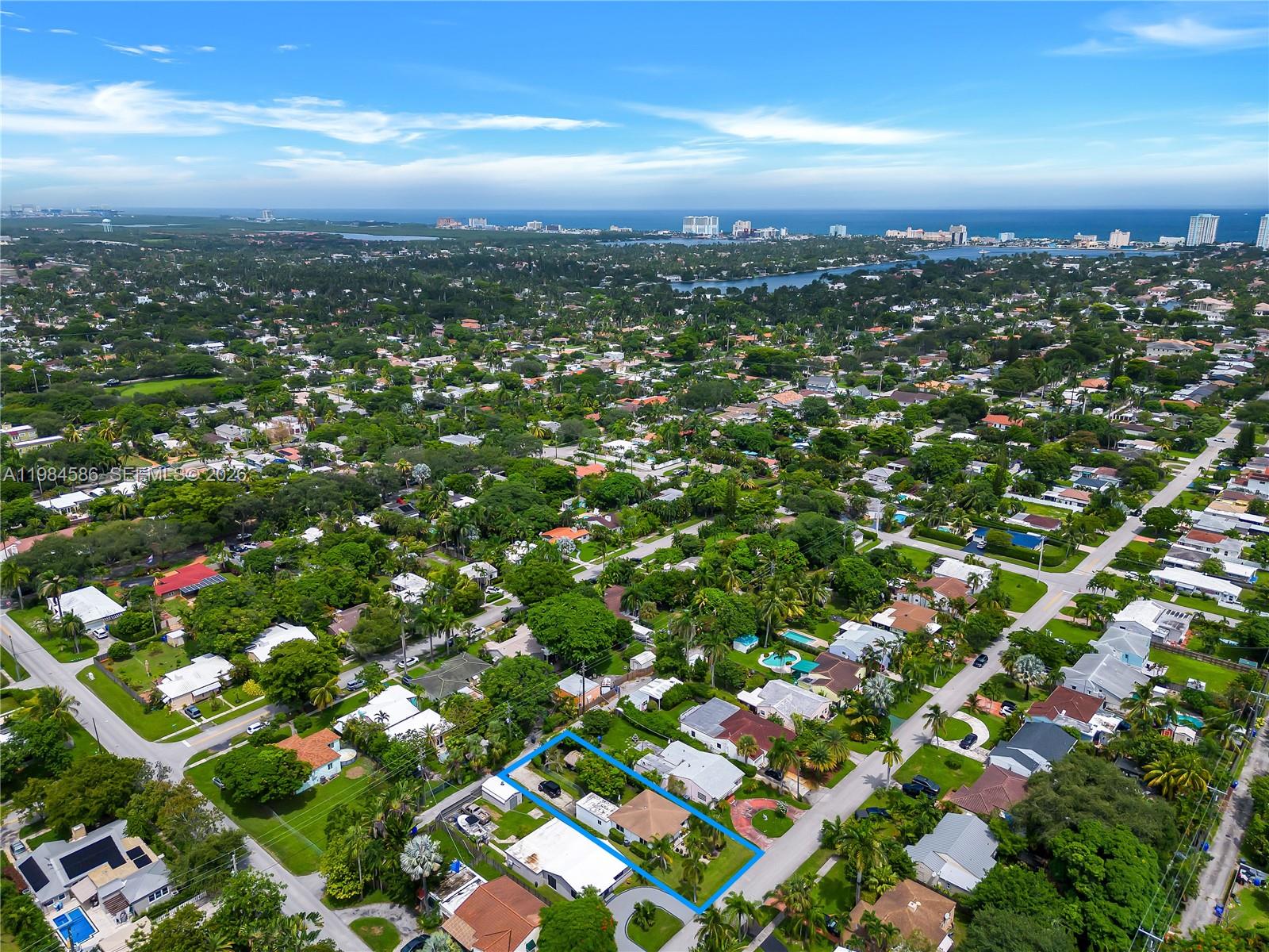 An aerial view shows a single-story house with a tan roof and a fenced backyard — 1539 Funston St, Hollywood FL 33020, HOLLYWOOD, FL