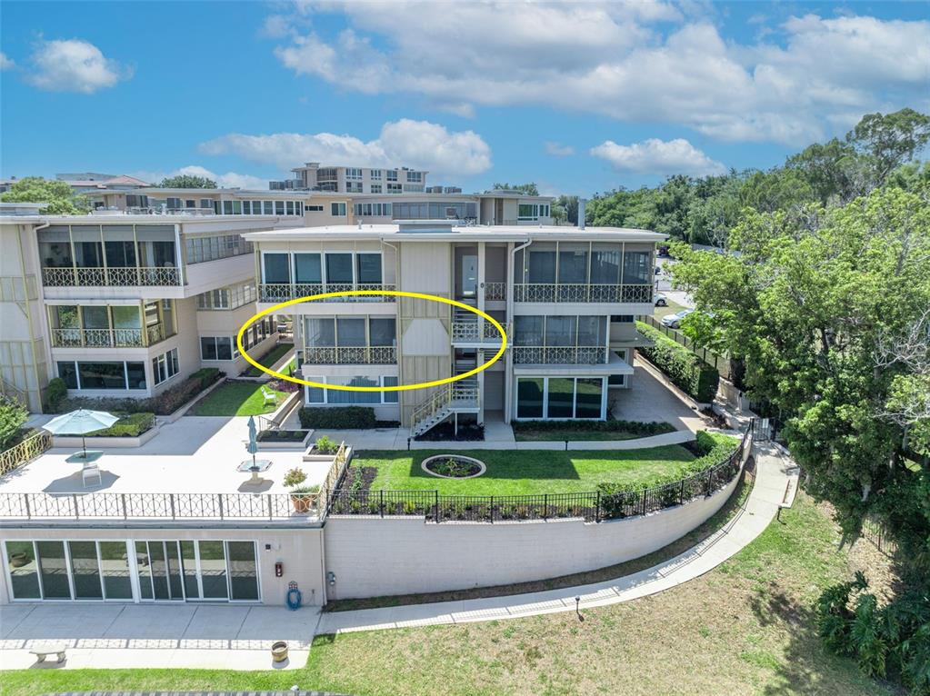 An exterior view of a multi-story apartment building with a circled screened-in balcony — 311 E MORSE BOULEVARD UNIT 1-3, WINTER PARK, FL