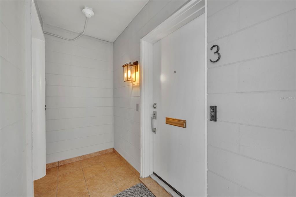 A white door marked with the number 3 sits in a tiled entryway — 311 E MORSE BOULEVARD UNIT 1-3, WINTER PARK, FL