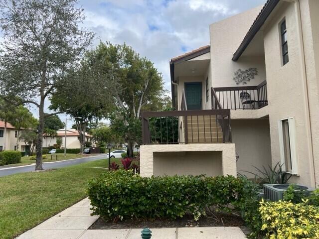 An exterior view of a two-story apartment building with a staircase and a balcony — 8436 Cypress Lane # 7d, Boca Raton FL 33433, BOCA RATON, FL