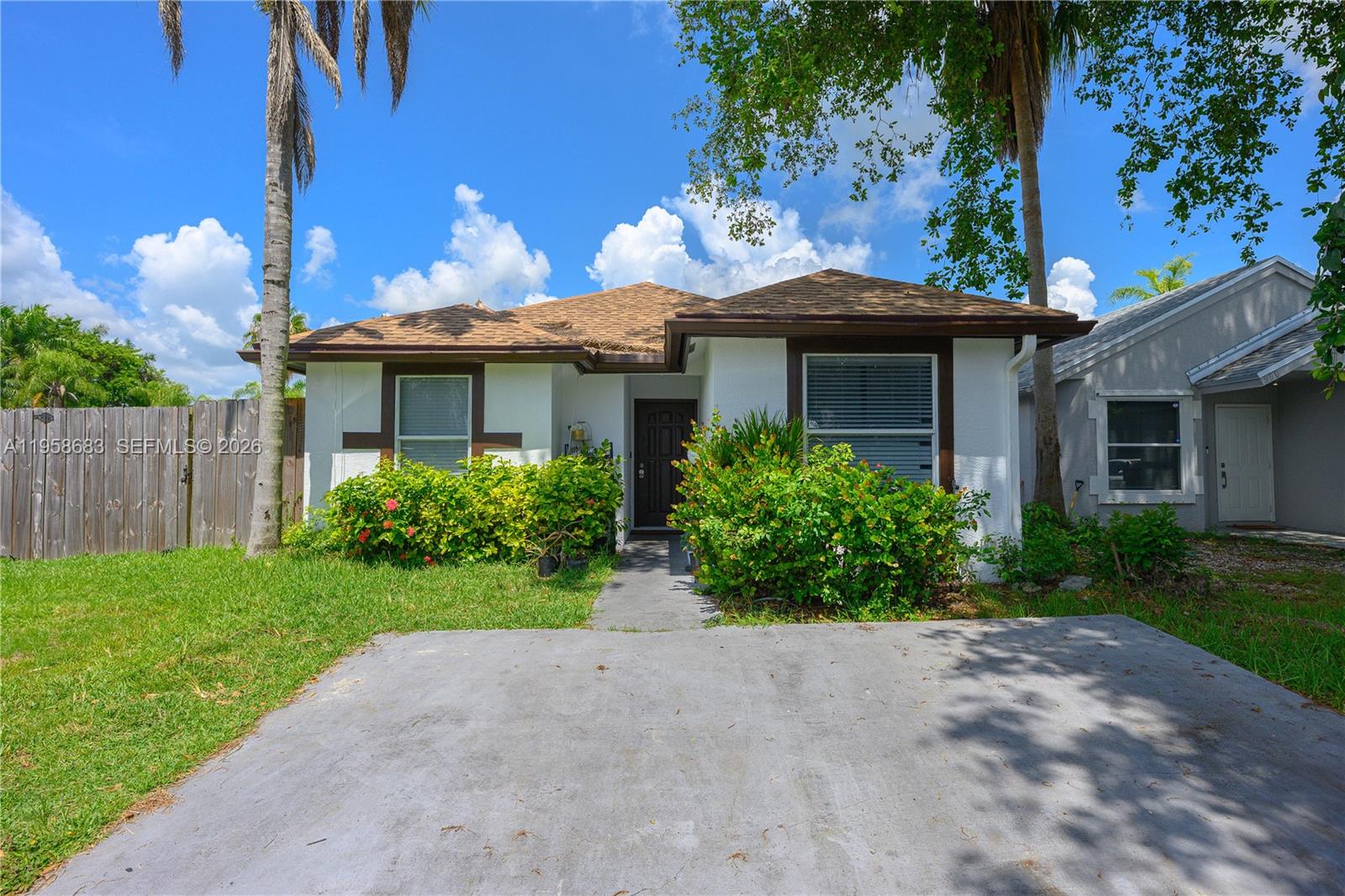 A single-story house with a white exterior, brown trim, and a concrete driveway — 998 SW 8th Pl, Florida City FL 33034, FLORIDA CITY, FL