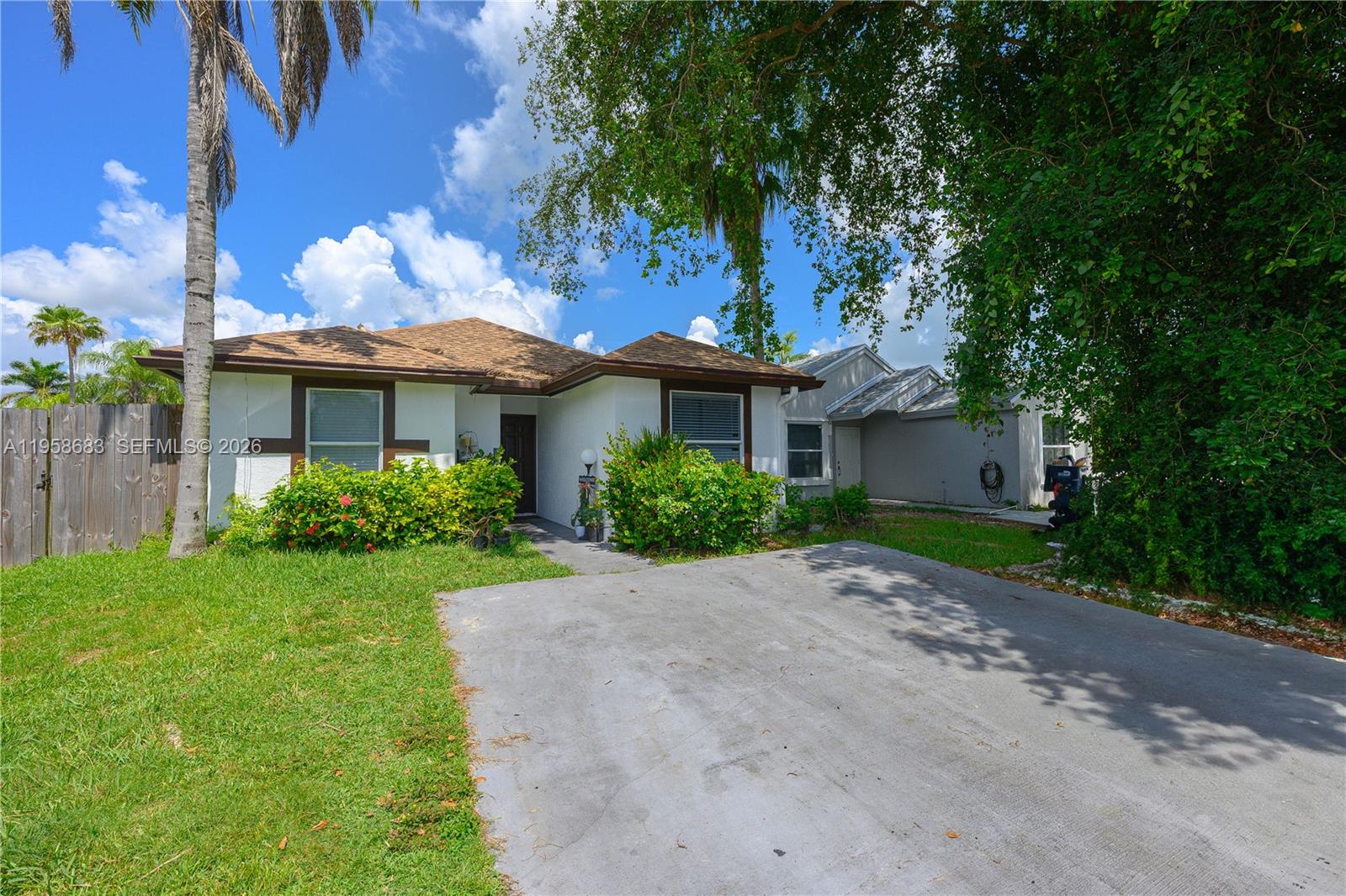 A single-story house with a brown roof, white walls, and a concrete driveway — 998 SW 8th Pl, Florida City FL 33034, FLORIDA CITY, FL