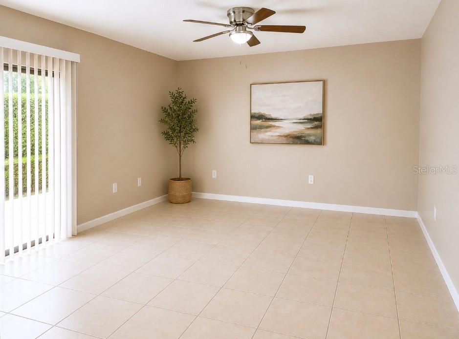 A room with beige walls, tile flooring, a ceiling fan, and a sliding glass door — 1152 OLD SOUTH DRIVE, LAKELAND, FL