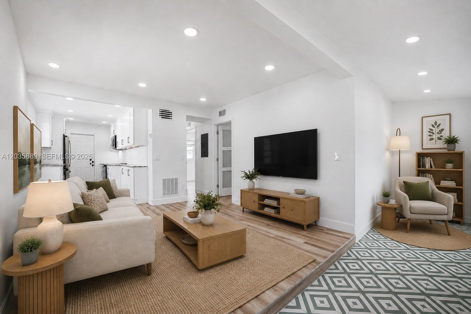 A living room features a beige sofa, wooden coffee table, television, and patterned tile flooring — 335 NE 12th Ave, Boynton Beach FL 33435, BOYNTON BEACH, FL