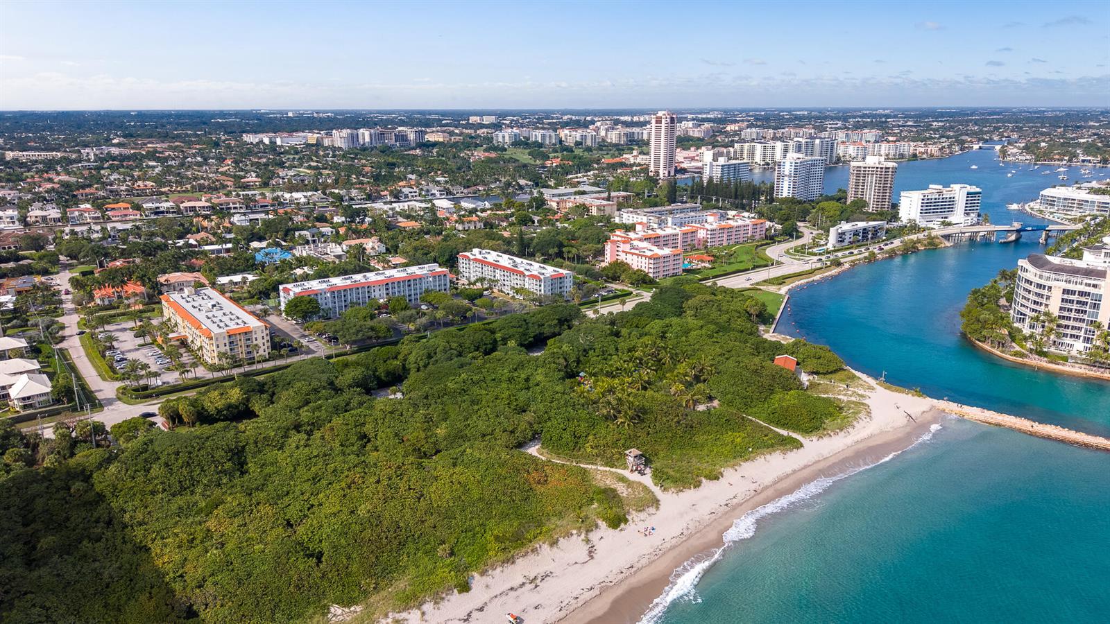 Aerial view of a coastal area with a beach, dense vegetation, and nearby residential buildings — 950 Ponce De Leon Road # 401, Boca Raton FL 33432, BOCA RATON, FL