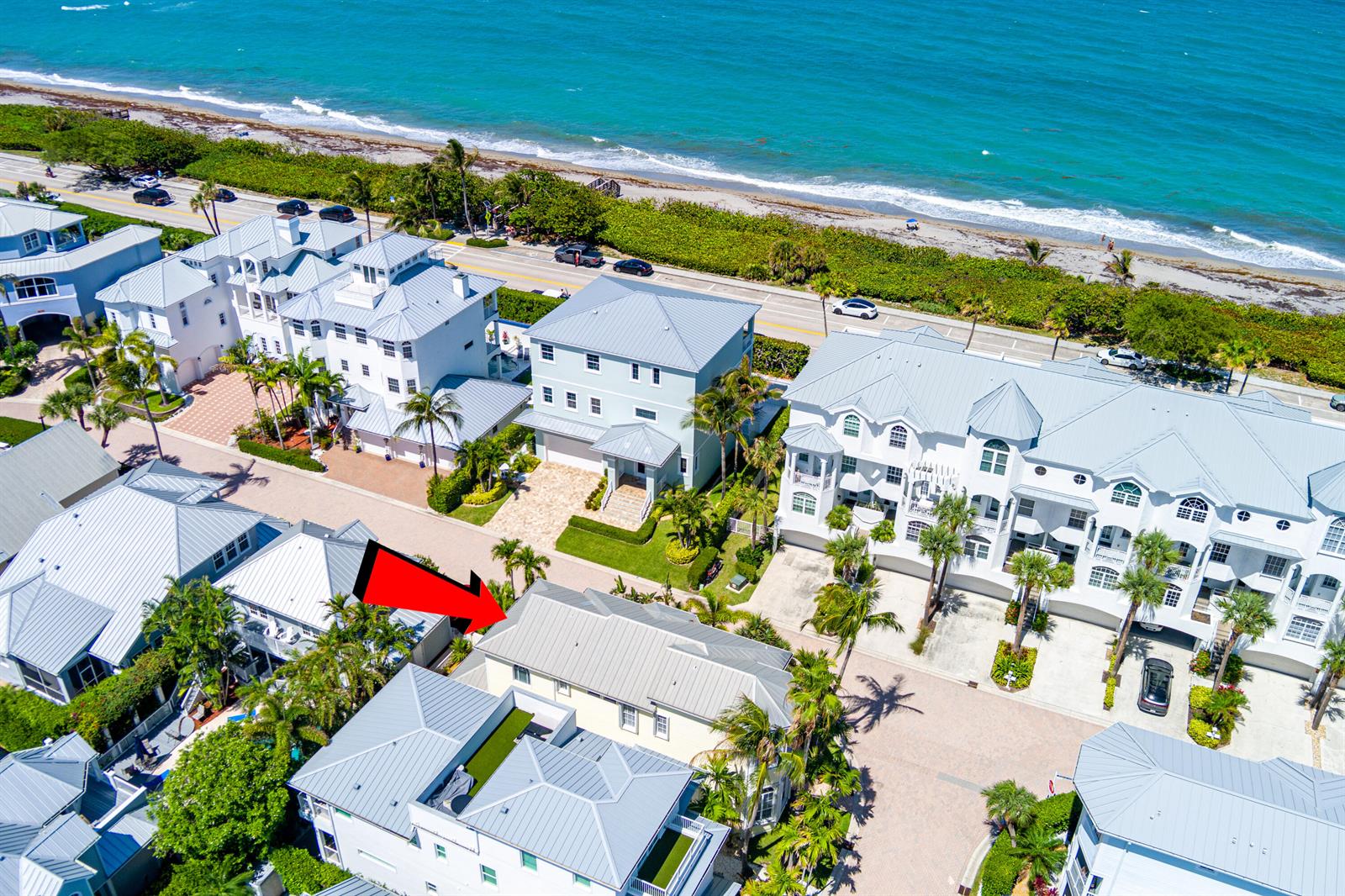 An aerial view shows a residential neighborhood with houses near a beach and ocean — 149 Key Lane, Jupiter FL 33477, JUPITER, FL