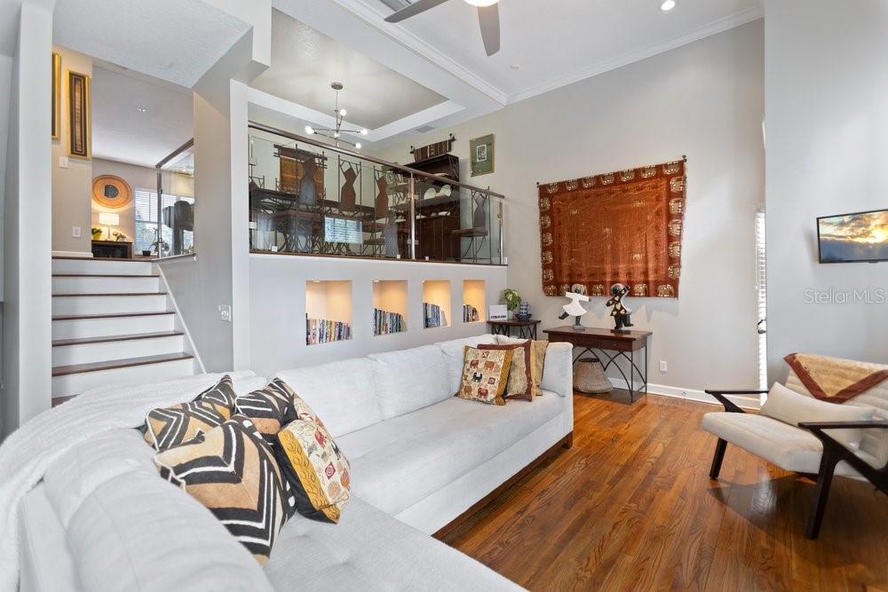 A living room with a white sectional sofa, hardwood floors, and a raised dining area — 919 S ROME AVENUE UNIT 8, TAMPA, FL