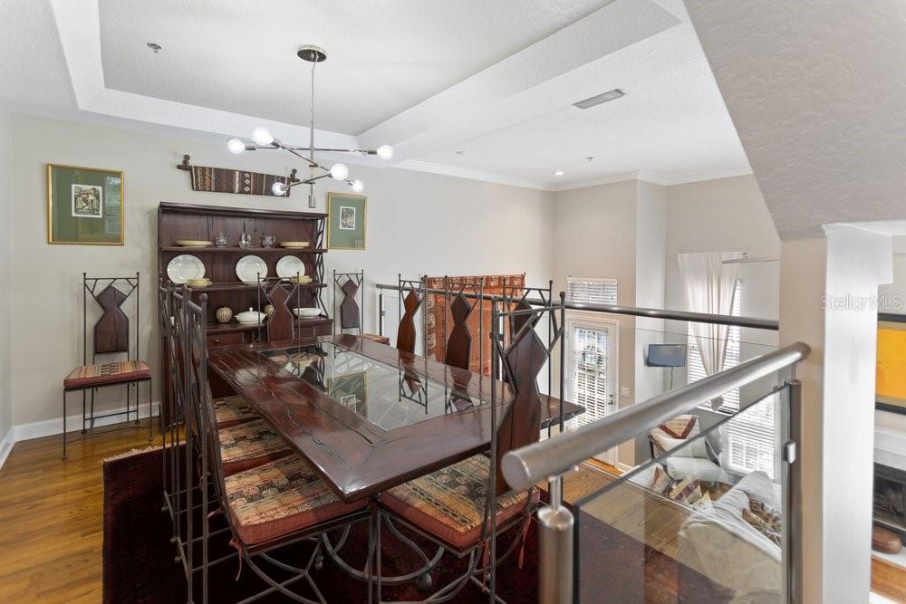 A dining room features a dark wood table, metal chairs, and a matching hutch — 919 S ROME AVENUE UNIT 8, TAMPA, FL