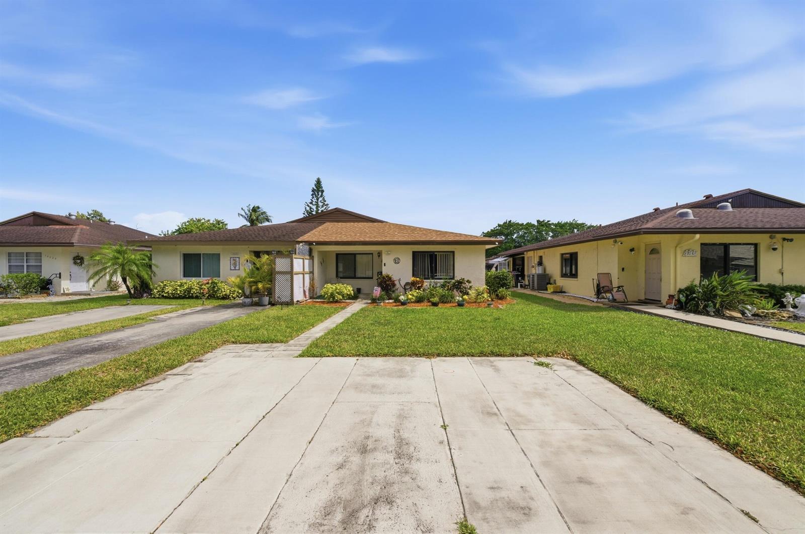 A single-story house with a concrete driveway, a front lawn, and a brown shingled roof — 10222 Pine Drive, Boynton Beach FL 33437, BOYNTON BEACH, FL