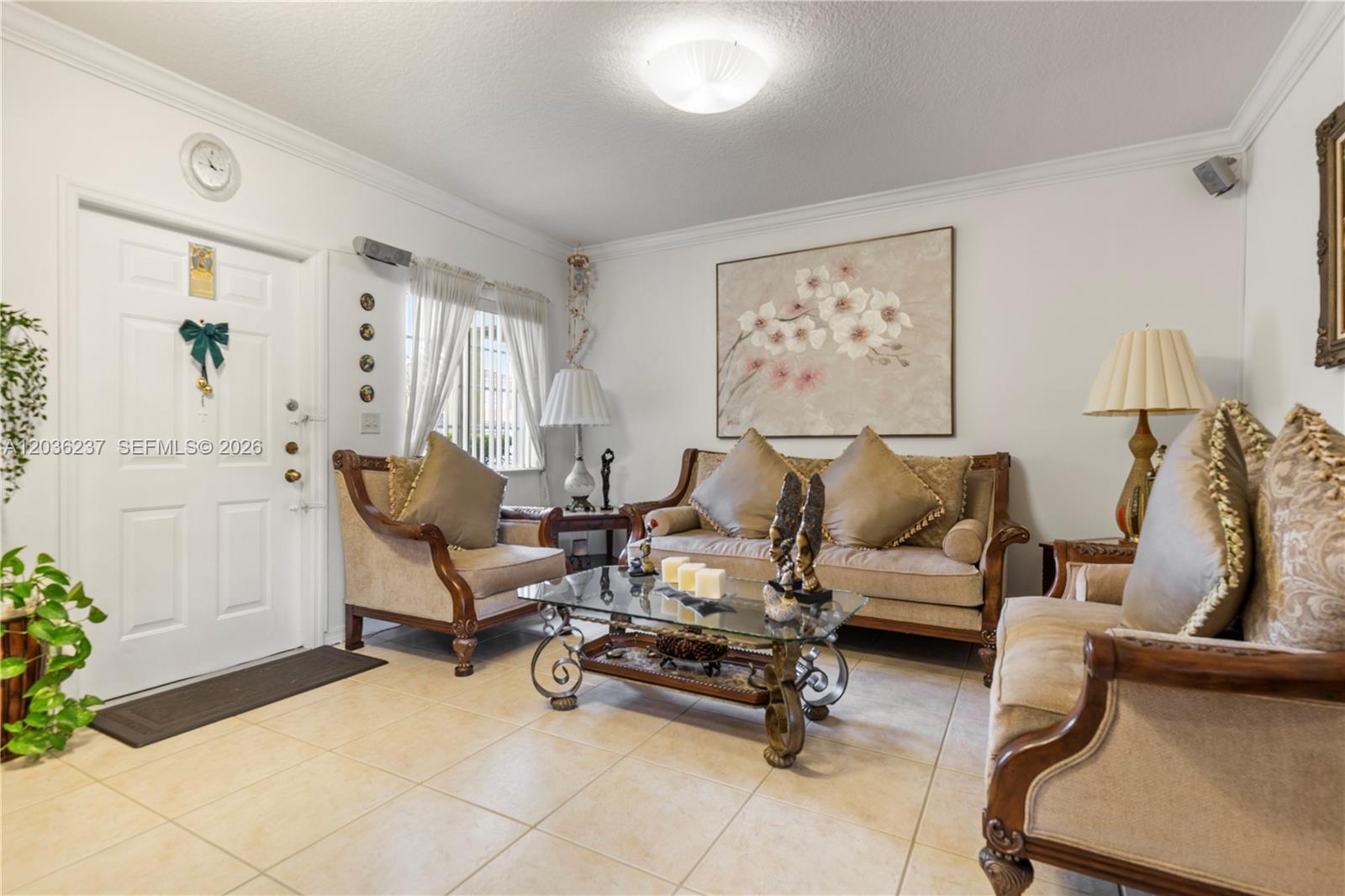 A living room features beige tile flooring, a glass coffee table, and traditional upholstered furniture — 13364 SW 143rd St, Miami FL 33186, MIAMI, FL