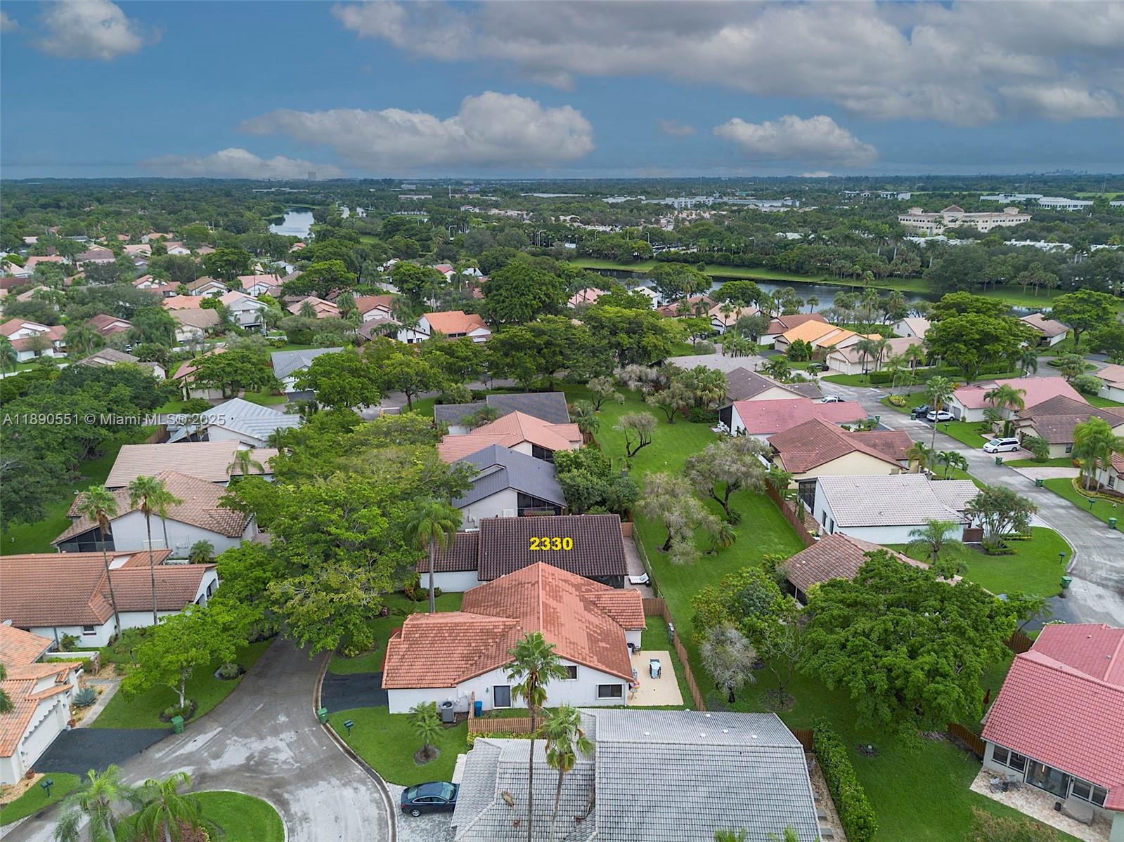 An aerial view shows a residential neighborhood with houses, green lawns, and mature trees — 2330 Dover, Weston FL 33326, WESTON, FL
