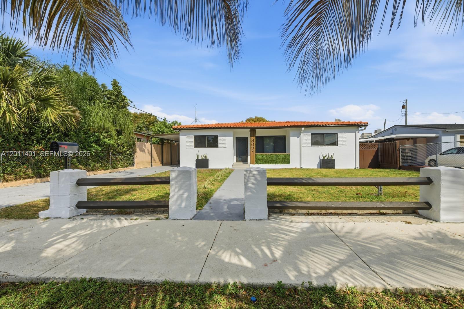 A single-story white house with a red tile roof and a front yard fence — 3021 SW 12th St, Miami FL 33135, MIAMI, FL