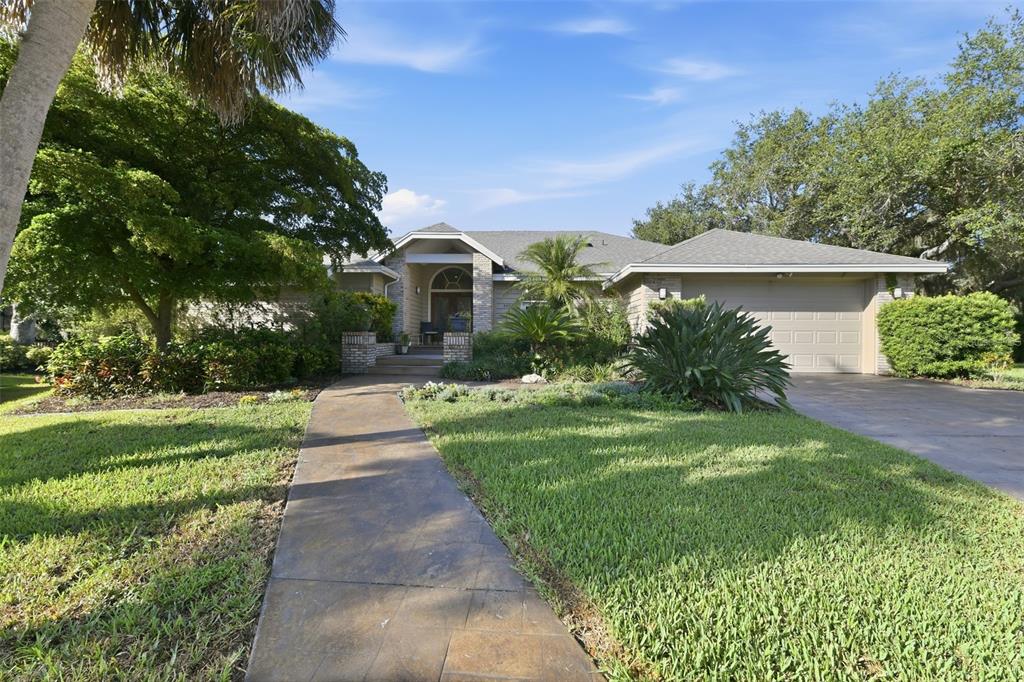 A single-story house with a tan exterior, a paved walkway, and a two-car garage — 4424 FRIAR TUCK LANE, SARASOTA, FL