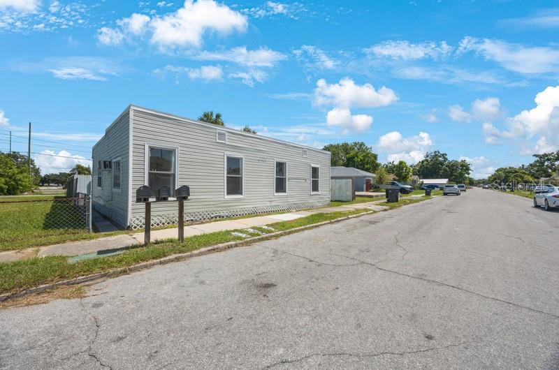 A light-colored, single-story building with three mailboxes stands along a residential street — 2753 53RD AVENUE N, ST PETERSBURG, FL