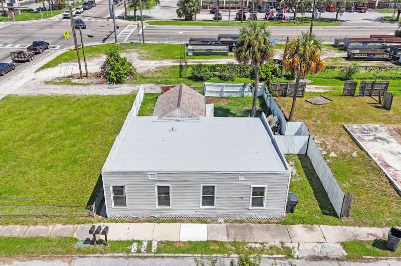 An aerial view shows a single-story gray building with a flat roof and a fenced yard — 2753 53RD AVENUE N, ST PETERSBURG, FL