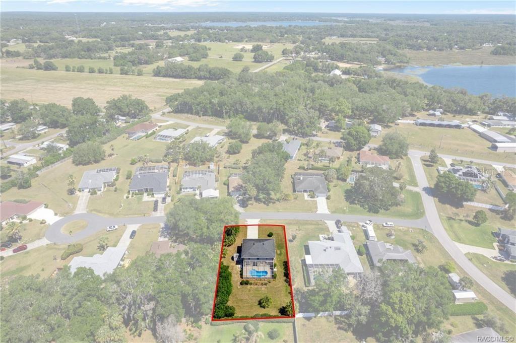 An aerial view shows a single-family home with a backyard pool outlined in red — 4482 E AVOCET COURT, INVERNESS, FL