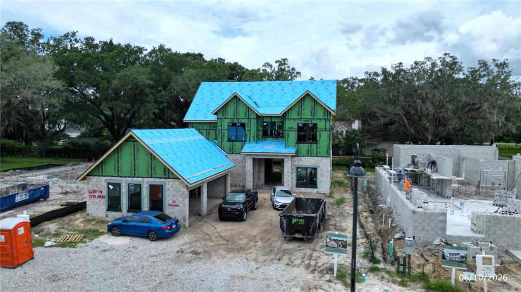 An aerial view shows a two-story house under construction with a blue roof and green sheathing — 1173 PRADO LANE, OAKLAND, FL