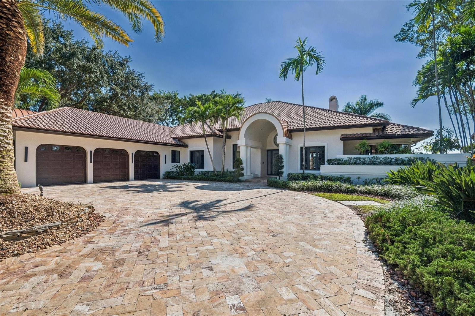 A single-story house with a tiled roof, three-car garage, and a paved circular driveway — 7600 Hyannis Lane, Parkland FL 33067, PARKLAND, FL