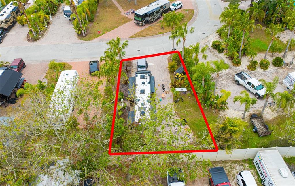 An aerial view shows an RV parked on a paved lot outlined in red — 6865 AMANDA VISTA CIRCLE, LAND O LAKES, FL