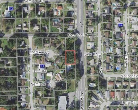An aerial map view shows a rectangular vacant lot highlighted in red within a residential neighborhood — MICHIGAN AVENUE, KISSIMMEE, FL