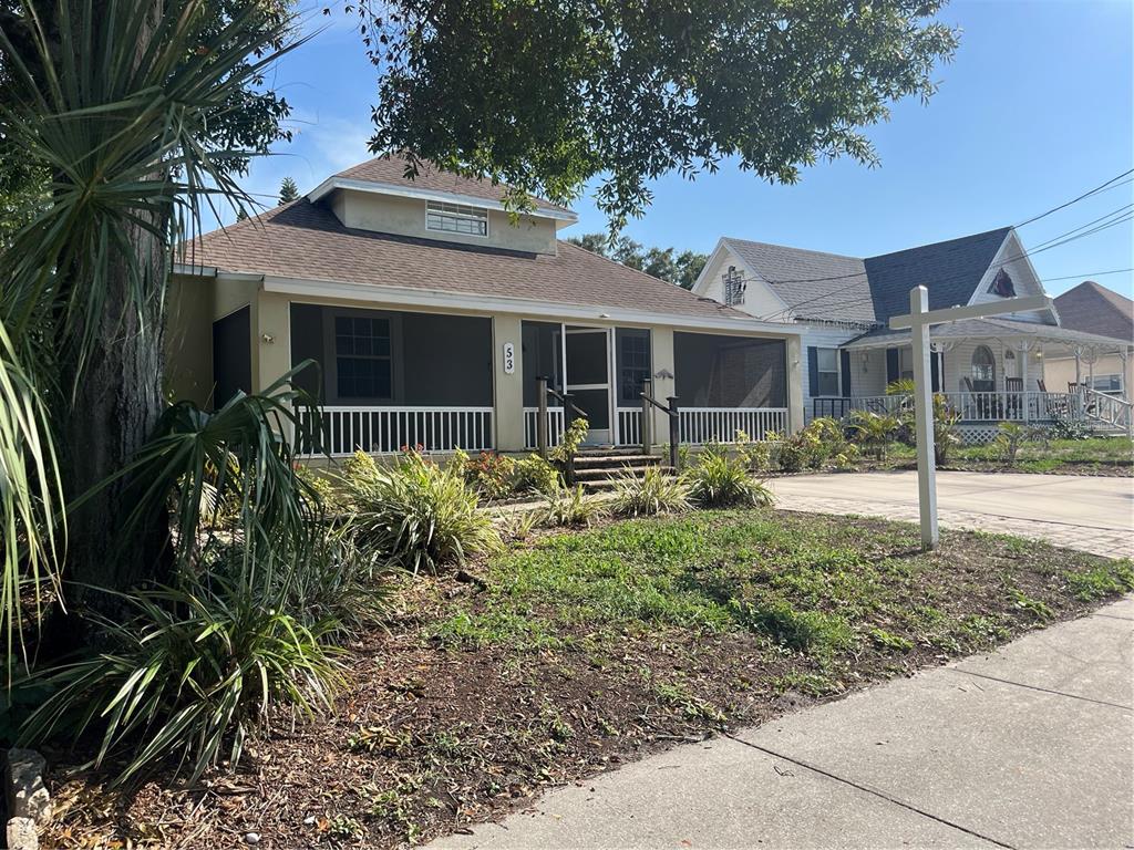 A single-story house with a screened-in front porch and a yard with landscaping — 53 W PARK STREET, TARPON SPRINGS, FL