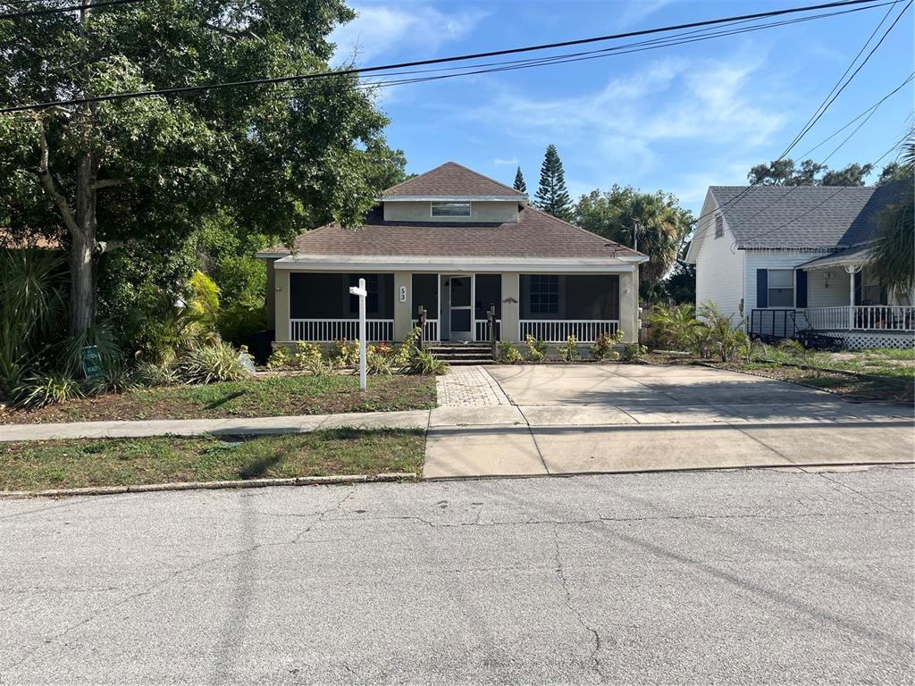 A single-story house with a screened front porch and a paved driveway — 53 W PARK STREET, TARPON SPRINGS, FL