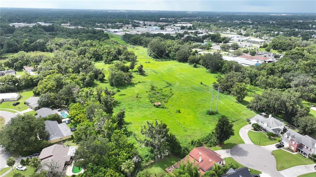 An aerial view shows a grassy utility easement running between residential neighborhoods and wooded areas — BRANNEN ROAD S, LAKELAND, FL