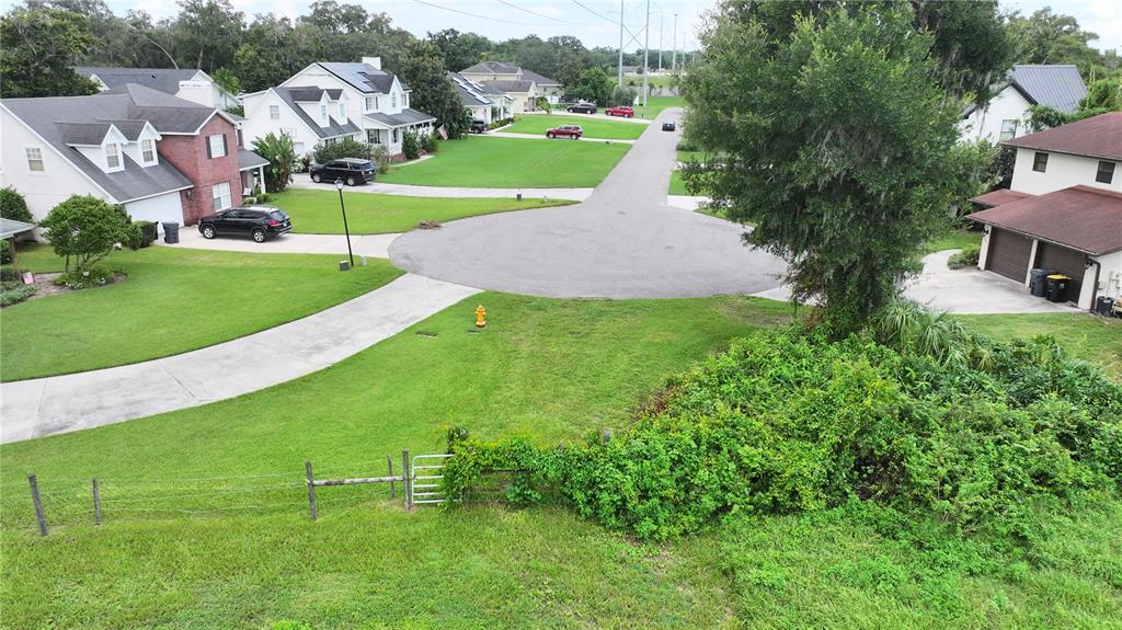 An aerial view shows a suburban cul-de-sac with houses, driveways, and a grassy yard — BRANNEN ROAD S, LAKELAND, FL