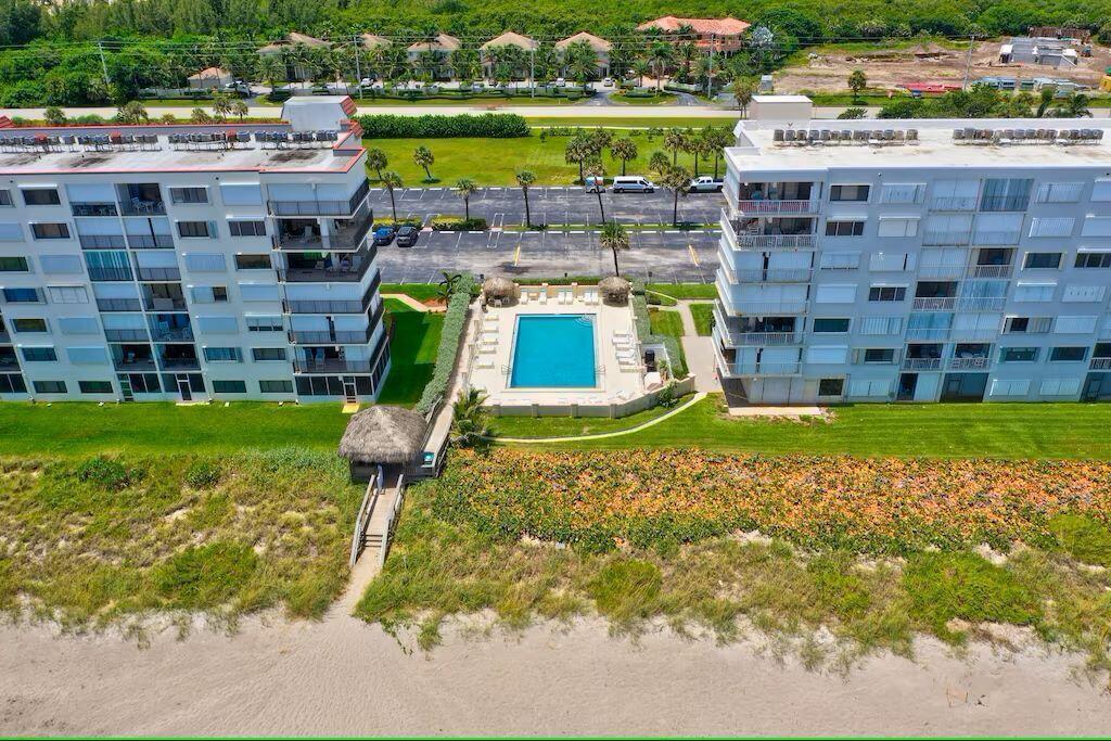 An aerial view of two apartment buildings with a central swimming pool near the beach — 10102 S Ocean Drive # 107, Jensen Beach FL 34957, JENSEN BEACH, FL