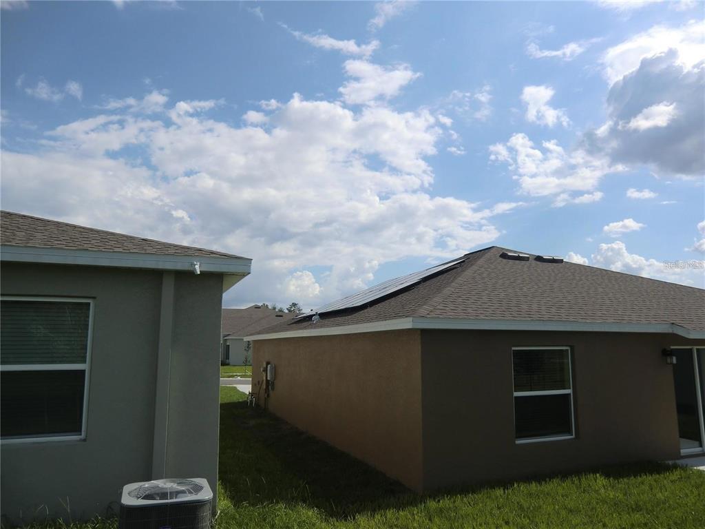 The exterior of two adjacent houses features a solar panel array on one roof — 780 DARING DRIVE, DAVENPORT, FL