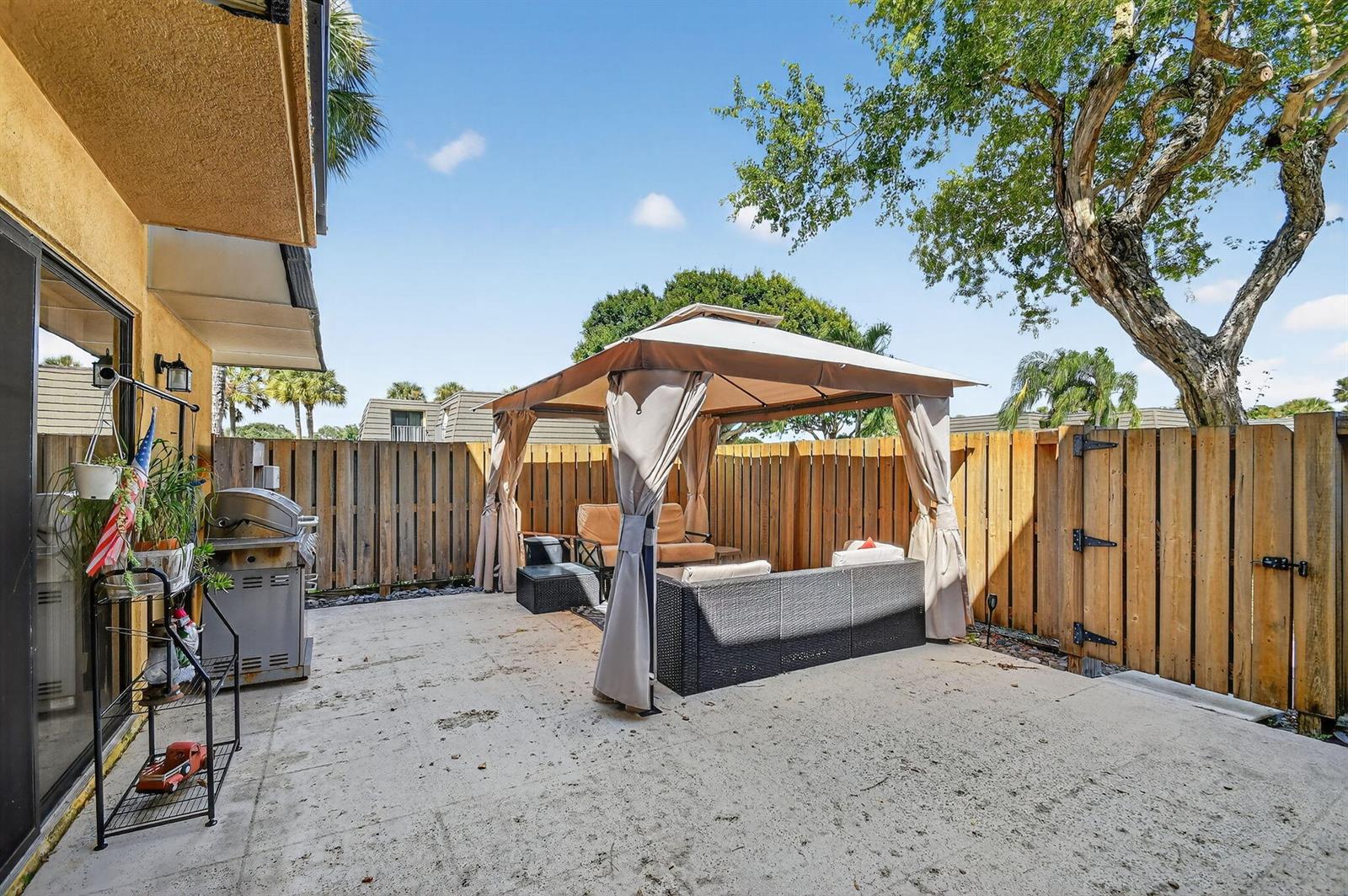 A room with gray walls, dark wood flooring, a staircase with white railings, and a ceiling fan — 2409 24th Way, West Palm Beach FL 33407, WEST PALM BEACH, FL