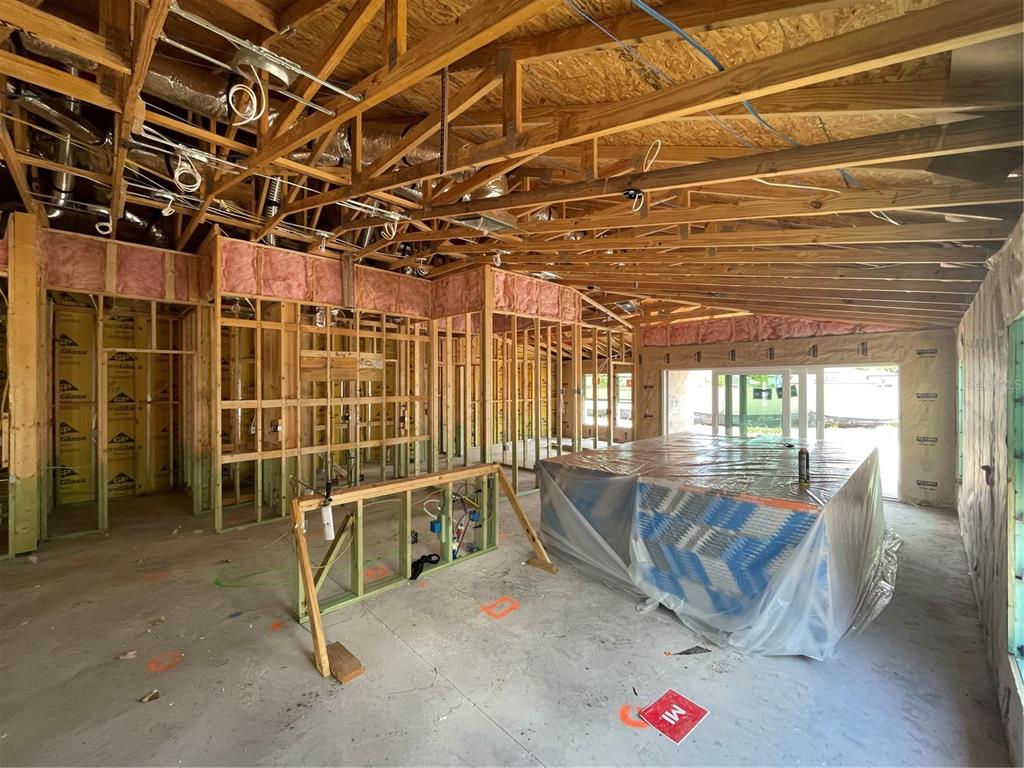 An interior view of a house under construction with exposed wooden framing and insulation — 12361 OAK  HILL WAY, PARRISH, FL