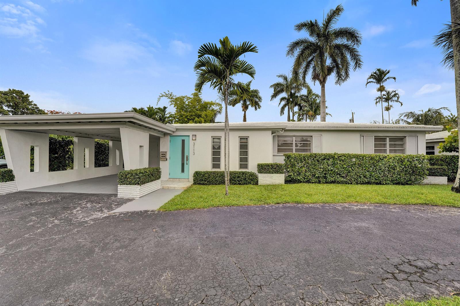 A single-story house with a turquoise front door, a carport, and palm trees — 3113 Hollywood Boulevard, Hollywood FL 33021, HOLLYWOOD, FL