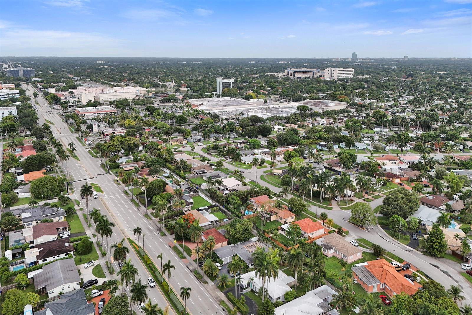 An aerial view shows a suburban neighborhood with a main road and commercial buildings — 3113 Hollywood Boulevard, Hollywood FL 33021, HOLLYWOOD, FL