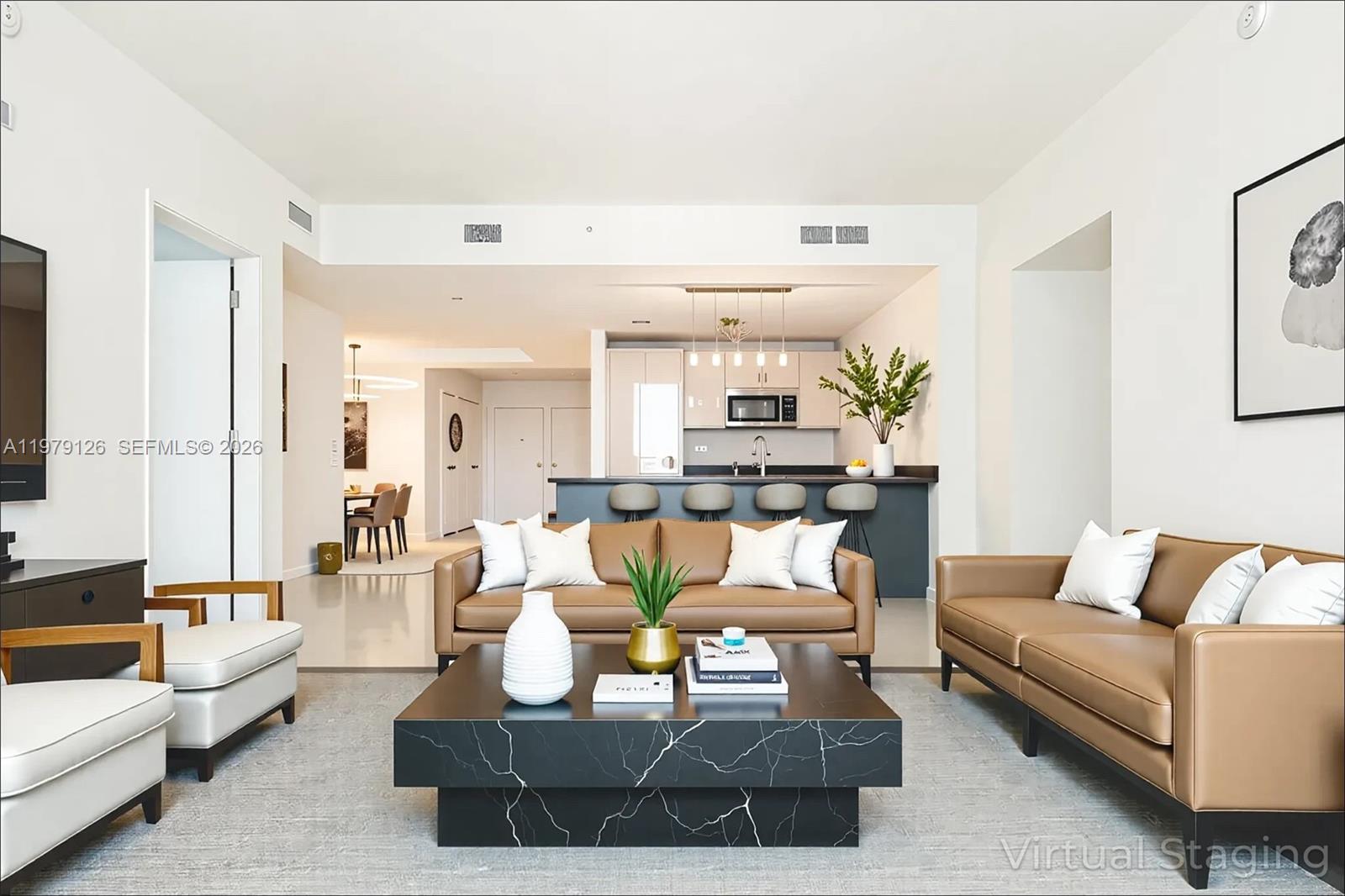 A living room with tan leather sofas, a black marble coffee table, and an open kitchen — 1010 Brickell Ave # 1902, Miami FL 33131, MIAMI, FL