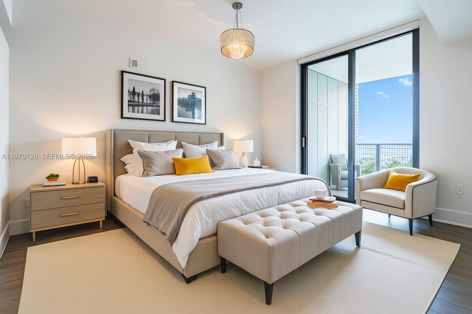 A modern bedroom features a king bed, tufted bench, and balcony access with water views — 1010 Brickell Ave # 1902, Miami FL 33131, MIAMI, FL