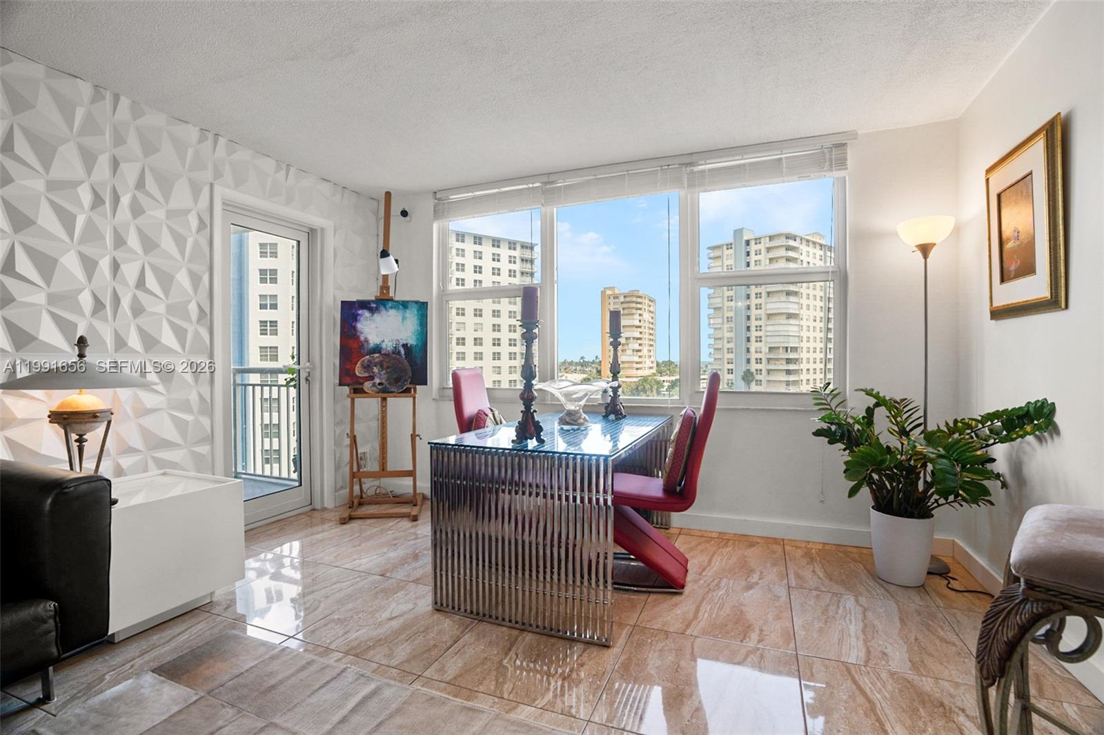 A dining area features a glass-topped table, red chairs, tiled floors, and a balcony door — 201 N Ocean Blvd # 509, Pompano Beach FL 33062, POMPANO BEACH, FL