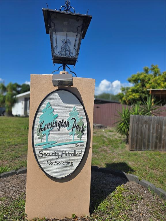 A tan pillar with a lantern and a Kensington Park sign stands in a yard — 2007 ELK AVENUE, SARASOTA, FL