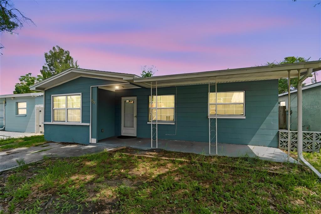 A teal, single-story house with a covered front porch and a concrete driveway — 3521 74TH AVENUE N, PINELLAS PARK, FL