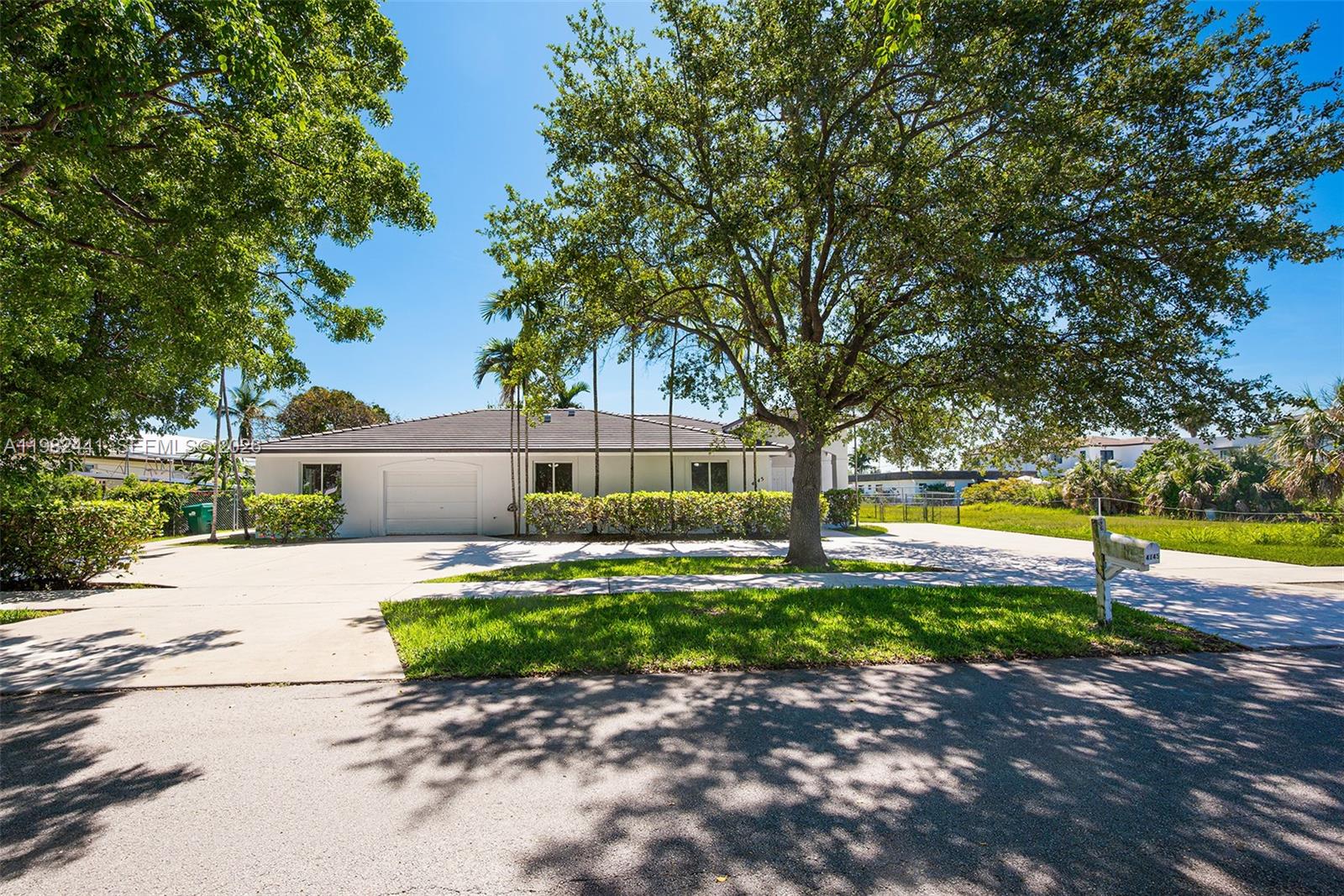 A single-story white house with a garage and a large tree in the front yard — 4145 SW 84th Ct, Miami FL 33155, MIAMI, FL