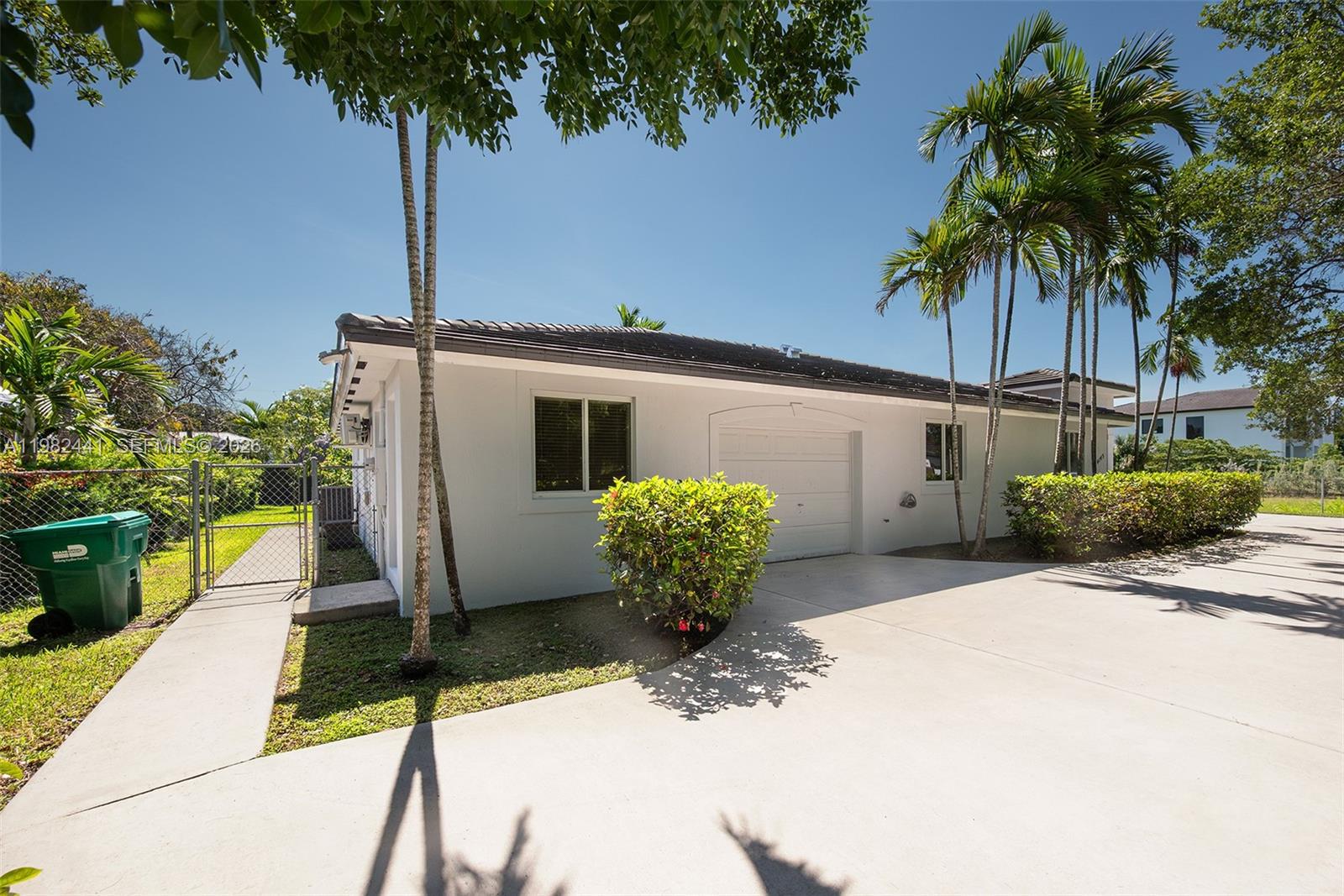 A white single-story house with a garage, concrete driveway, and palm trees — 4145 SW 84th Ct, Miami FL 33155, MIAMI, FL