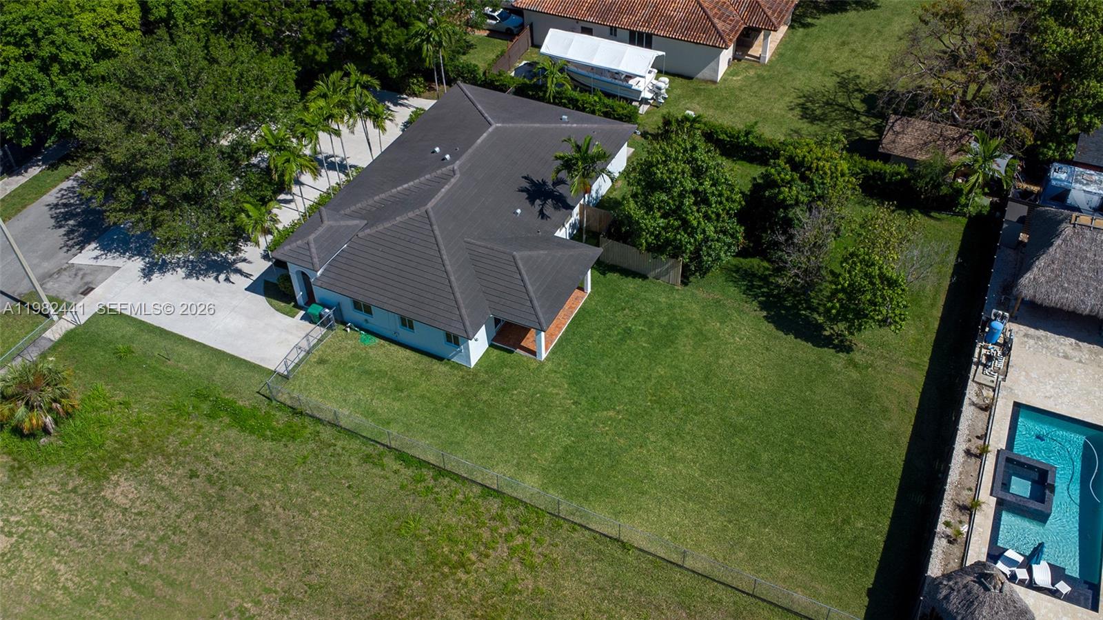 An aerial view shows a house with a dark roof, a large lawn, and a pool — 4145 SW 84th Ct, Miami FL 33155, MIAMI, FL