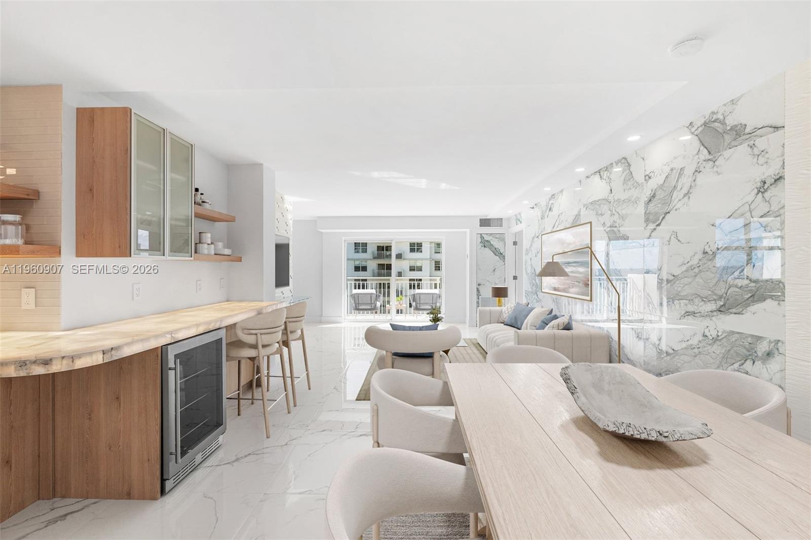 A modern open-concept living and dining area features marble flooring, wood cabinetry, and stone walls — 4505 S Ocean Blvd # 703, Highland Beach FL 33487, HIGHLAND BEACH, FL