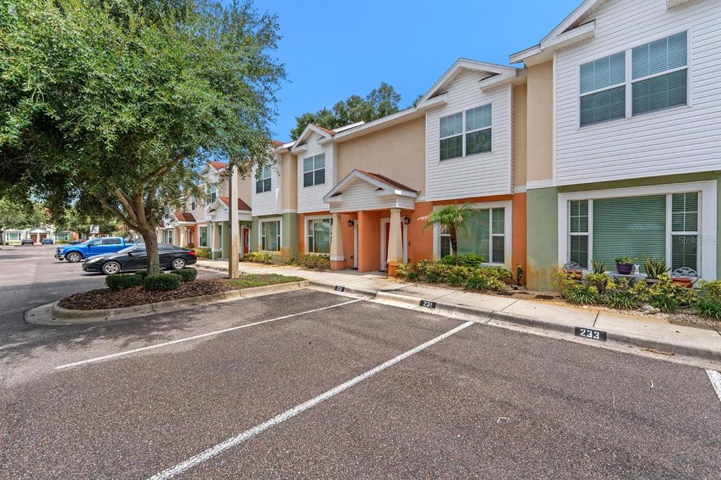 A row of two-story townhomes with parking spaces in the foreground — 231 ALEXANDER WOODS DRIVE, PLANT CITY, FL